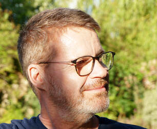 Philip Ellis in a garden.